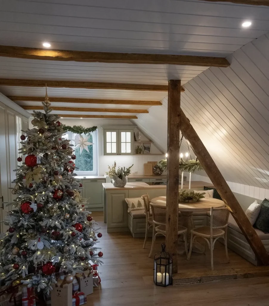 The full attic kitchen and dining area beneath exposed timber beams